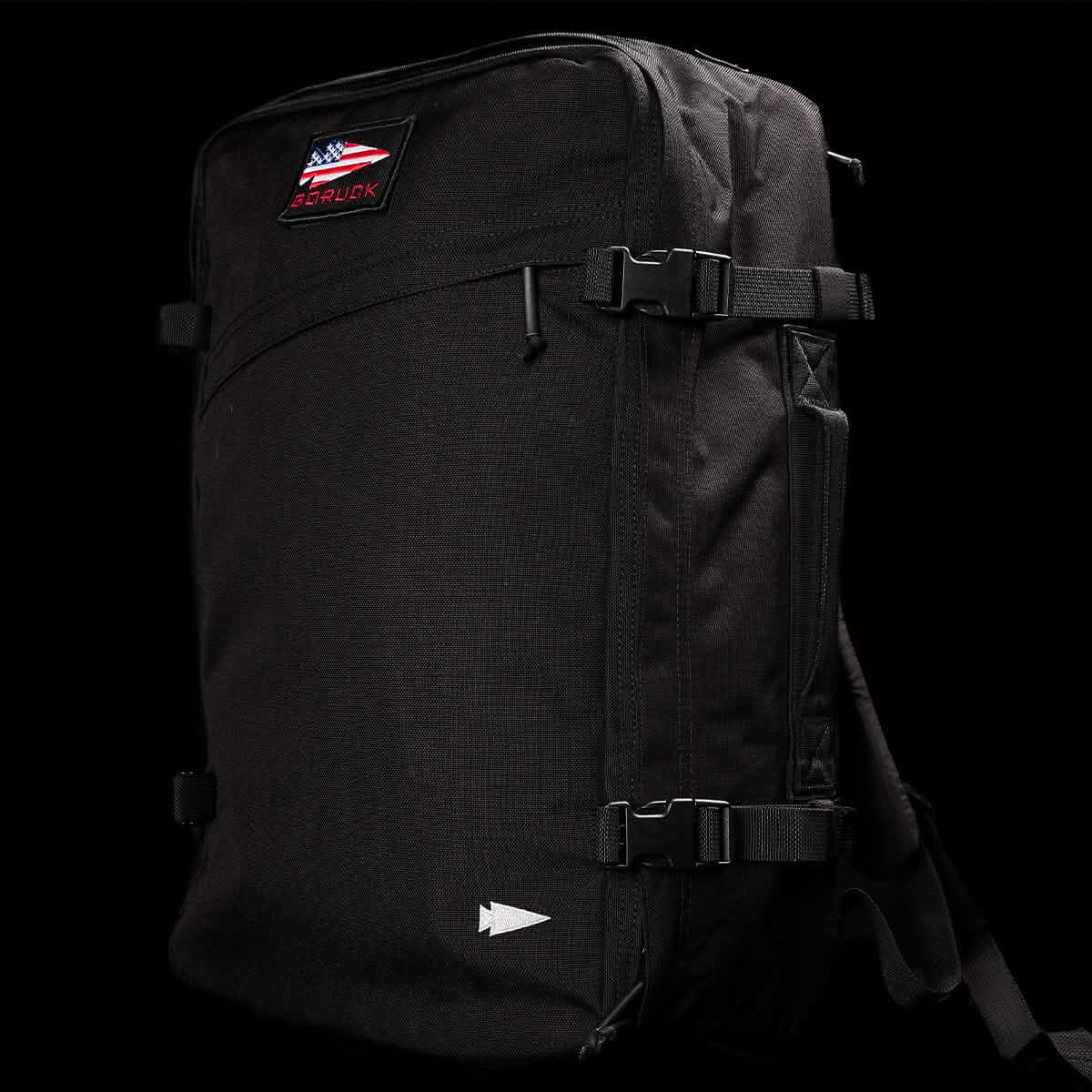 A sleek black GORUCK GR3 - Cordura carry-on rucksack showcases the GR3® logo above an American flag patch. It boasts water resistance, multiple straps, and a minimalist design.