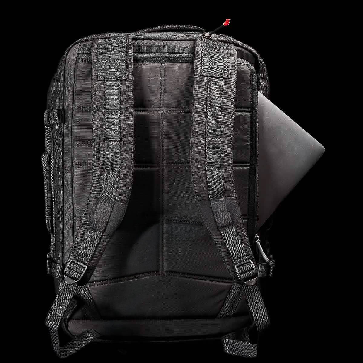 The GR3 is a black, water-resistant laptop backpack with padded straps and a laptop partially visible in the back compartment—ideal as a carry-on rucksack for travel.