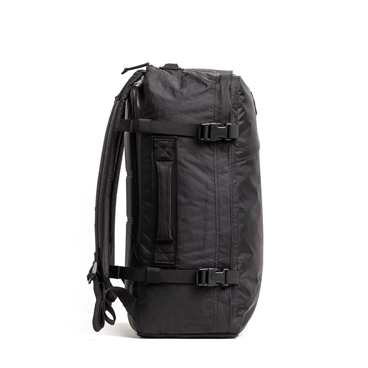 Black GORUCK rugged rucking backpack with compression straps and padded shoulder straps, side view