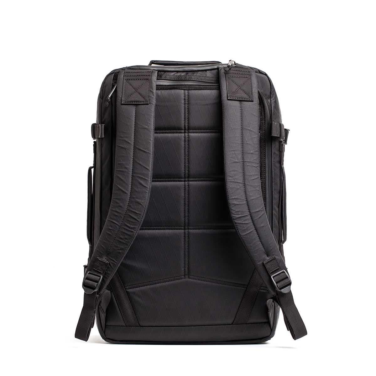 Back view of a black GORUCK rucksack with padded straps and quilted back panel for durable rucking gear