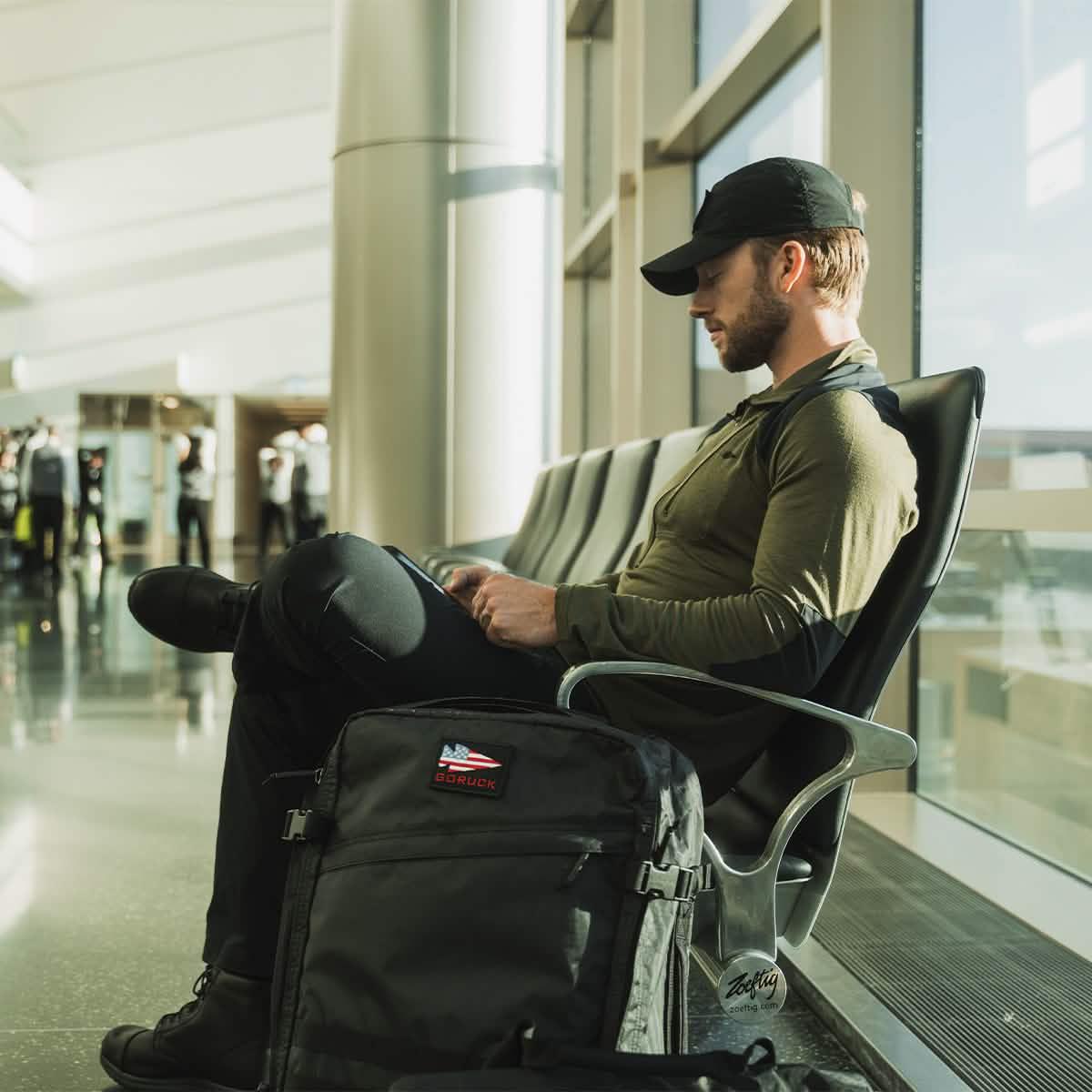 Man with GORUCK black Dyneema backpack sitting in airport terminal