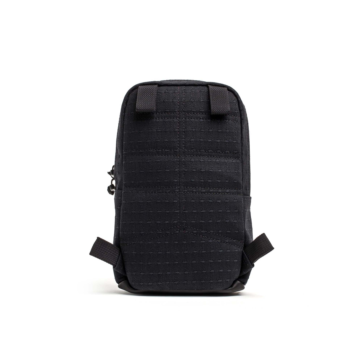 The Japanese Denim GRenade is a compact black rectangular pouch with a grid pattern, four attachment loops, and waterproof zippers—ideal as a cross-body bag for travel or daily use. White background.