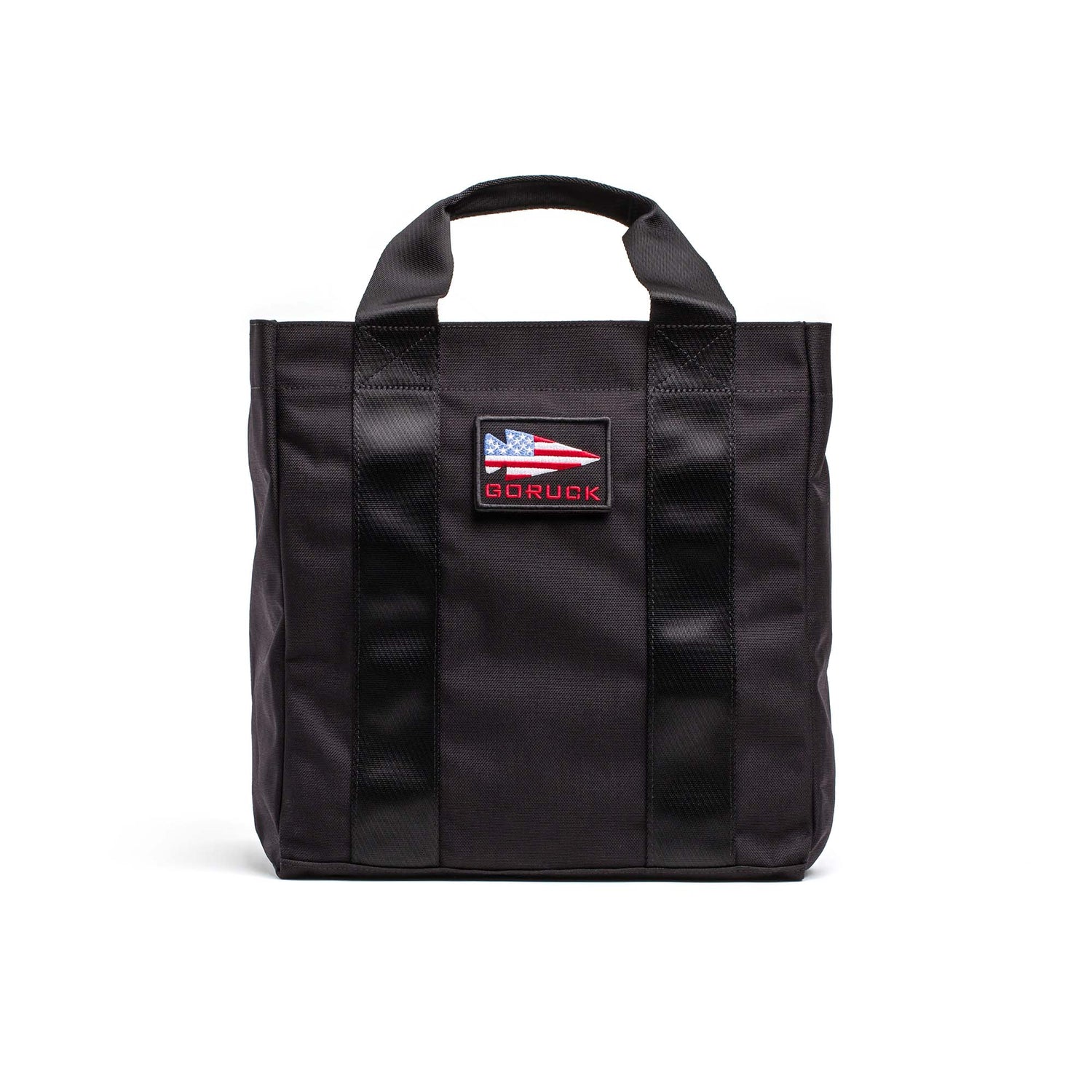 The Grocery Getter is a black GORUCK all-purpose tote bag with dual handles, made from rugged 1000D Cordura and featuring a GORUCK patch with an American flag on the front.