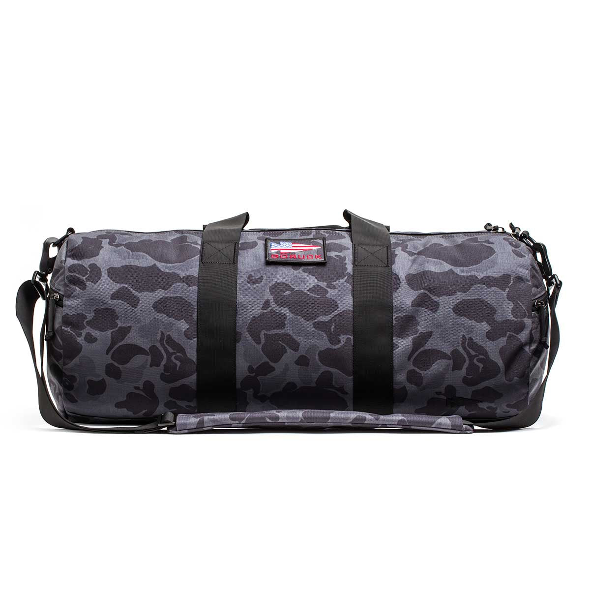 The Gym Bag - Cordura in gray with a black camo pattern features durable 1000D CORDURA fabric, black straps, a shoulder strap, and is displayed on a white background.