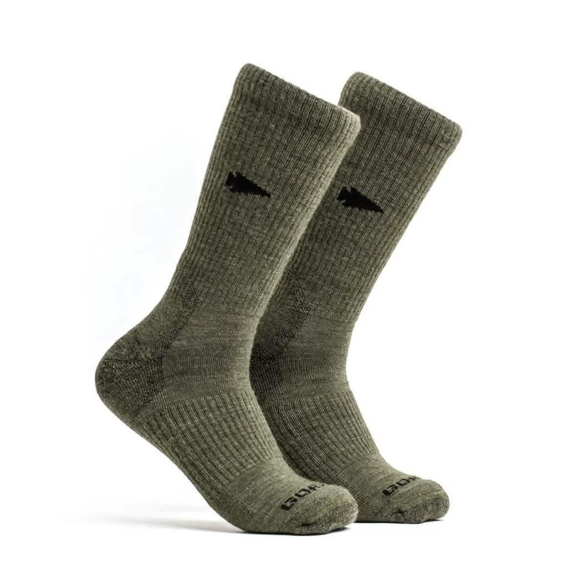 Pair of green merino wool crew socks with ribbed texture and black logo on side and toes