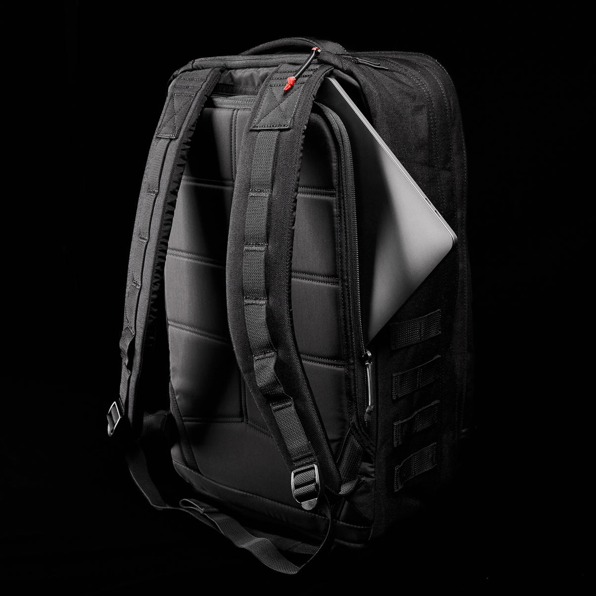 The GR2 - Ballistic Nylon Cordura, a black rucksack with a laptop partly visible in its back compartment, is shown against a black background and built for those seeking Special Forces-level durability.