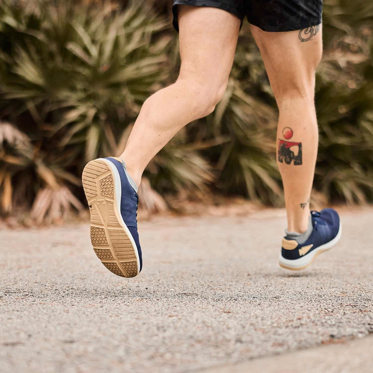 Close-up of runner wearing blue GORUCK rucking shoes on outdoor path
