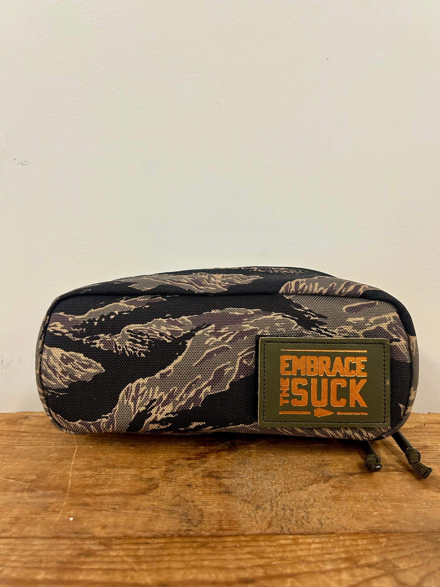 The Shadow Pocket- Tiger Stripe is a camo-patterned pouch made from rugged 1000D Cordura, featuring an