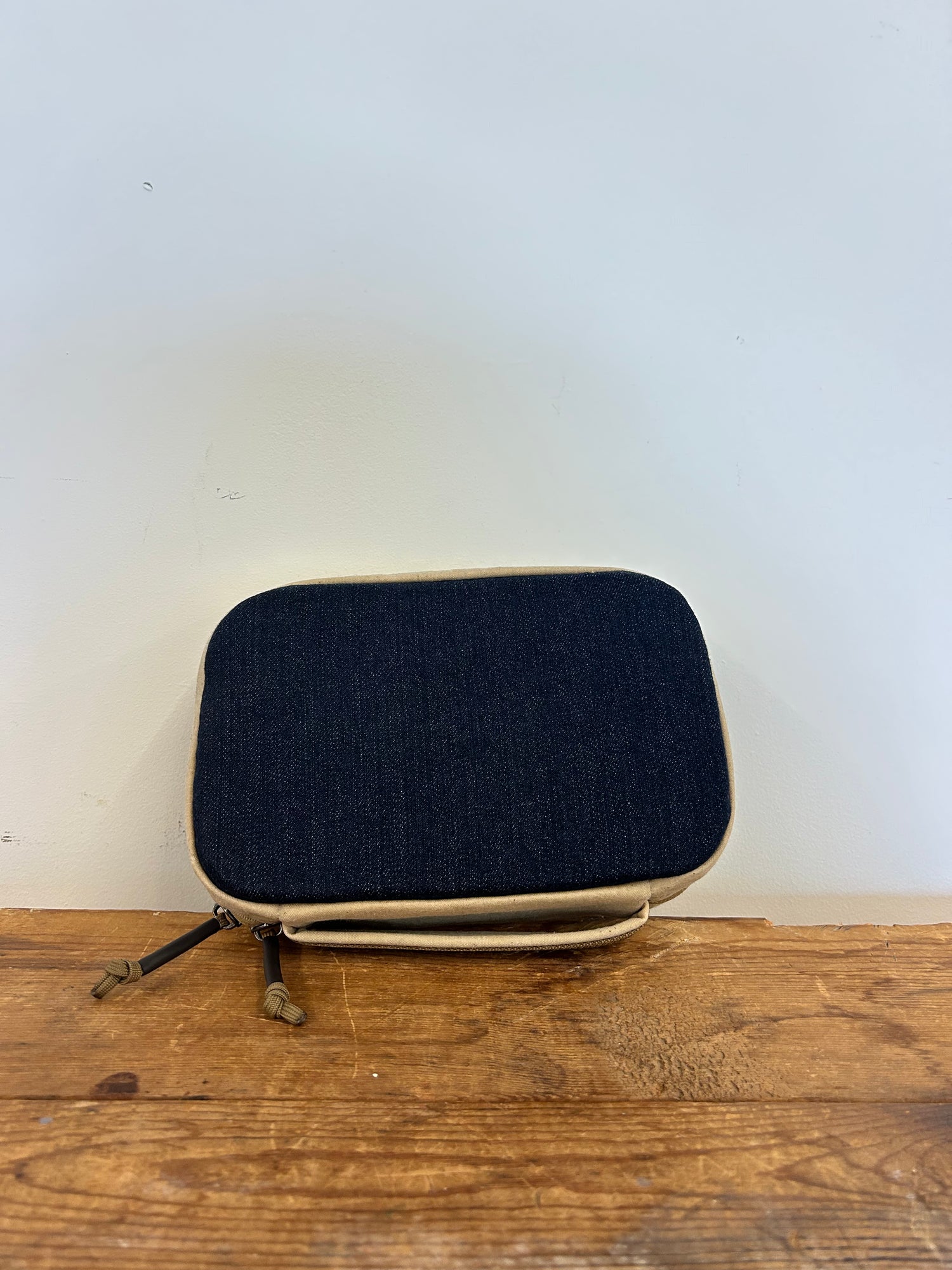 GORUCK compact black and tan gear pouch on wooden surface, minimalist rucking accessory