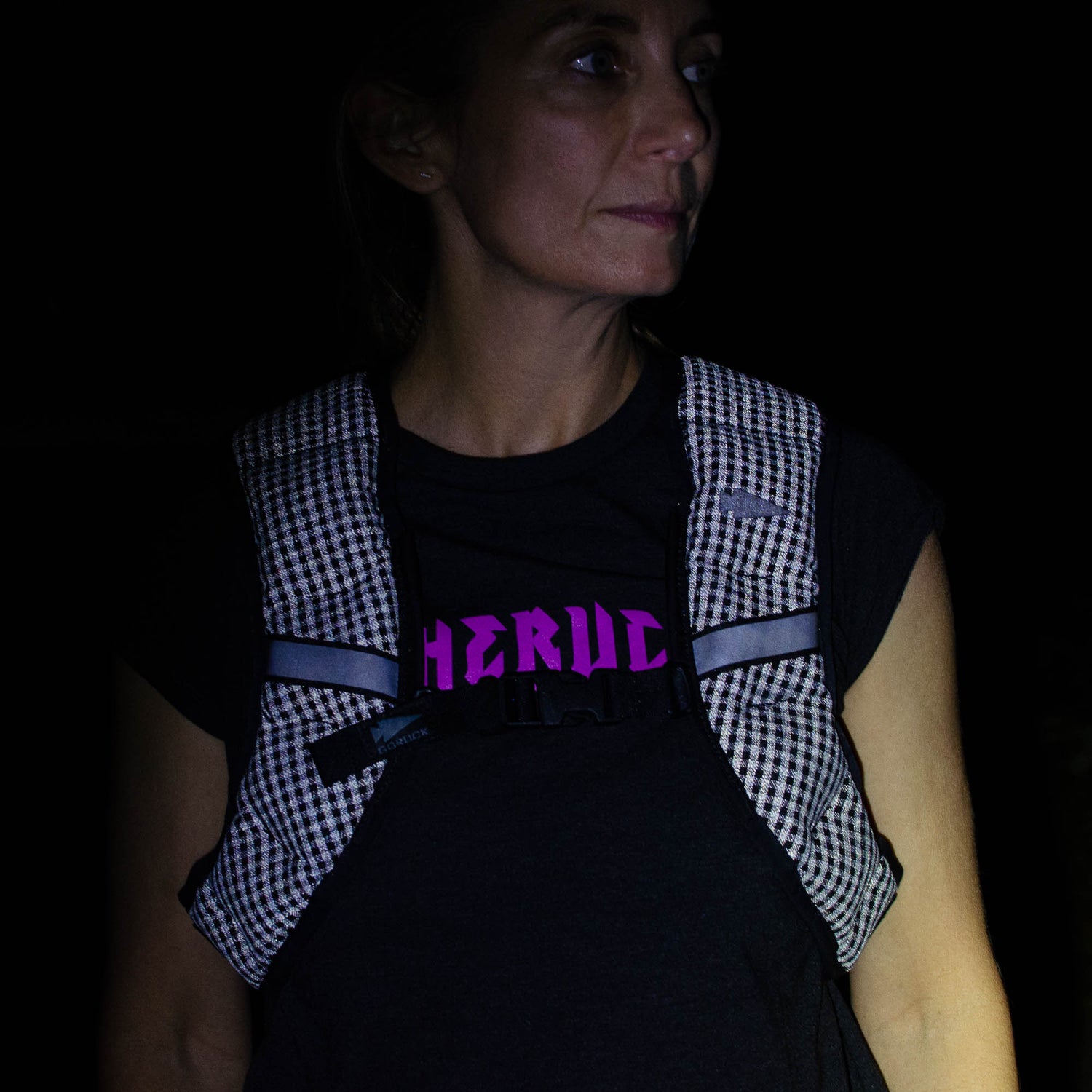 A woman wearing the Spy Ruck | Women's Weighted Vest over a black shirt with