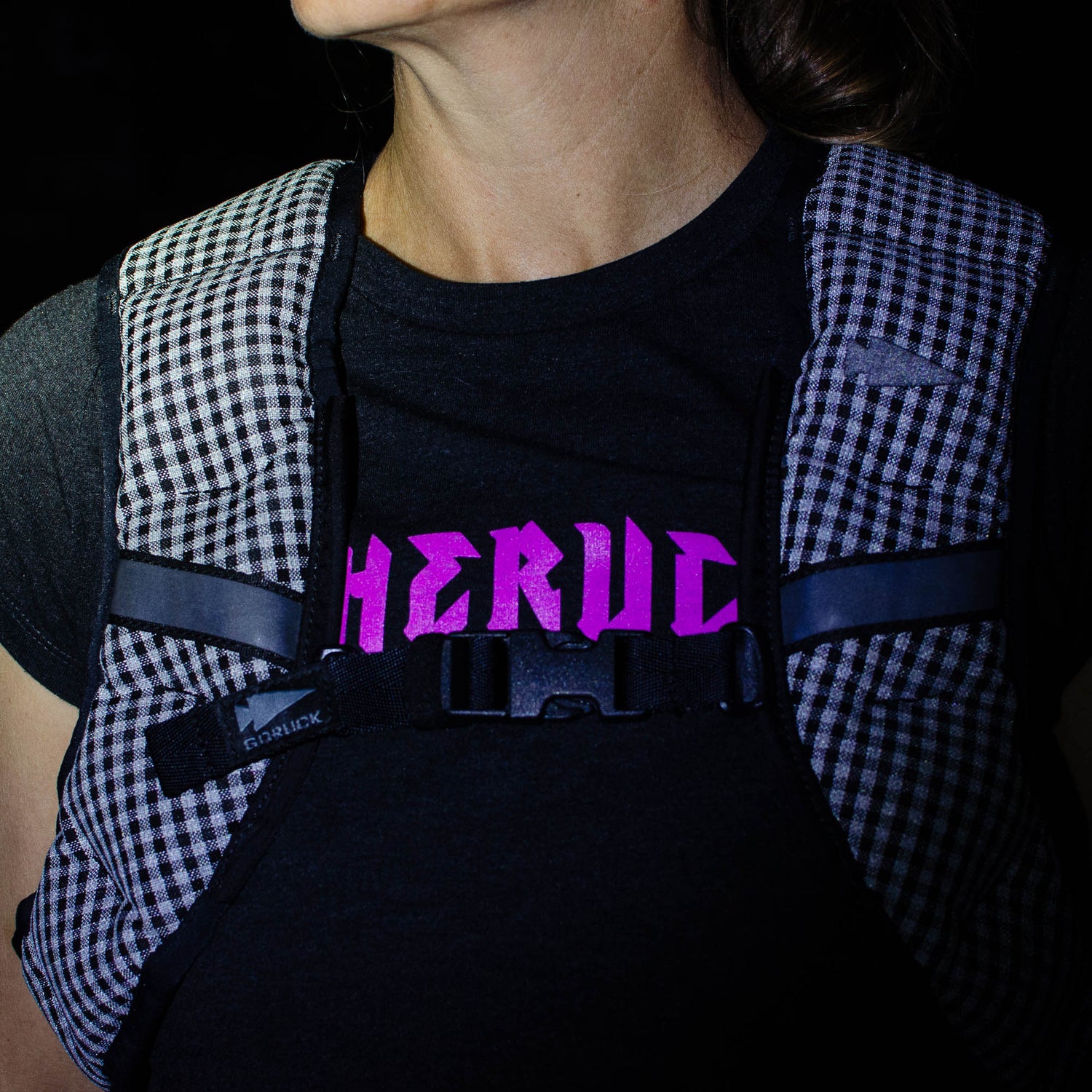 A person wears a checkered running vest and a