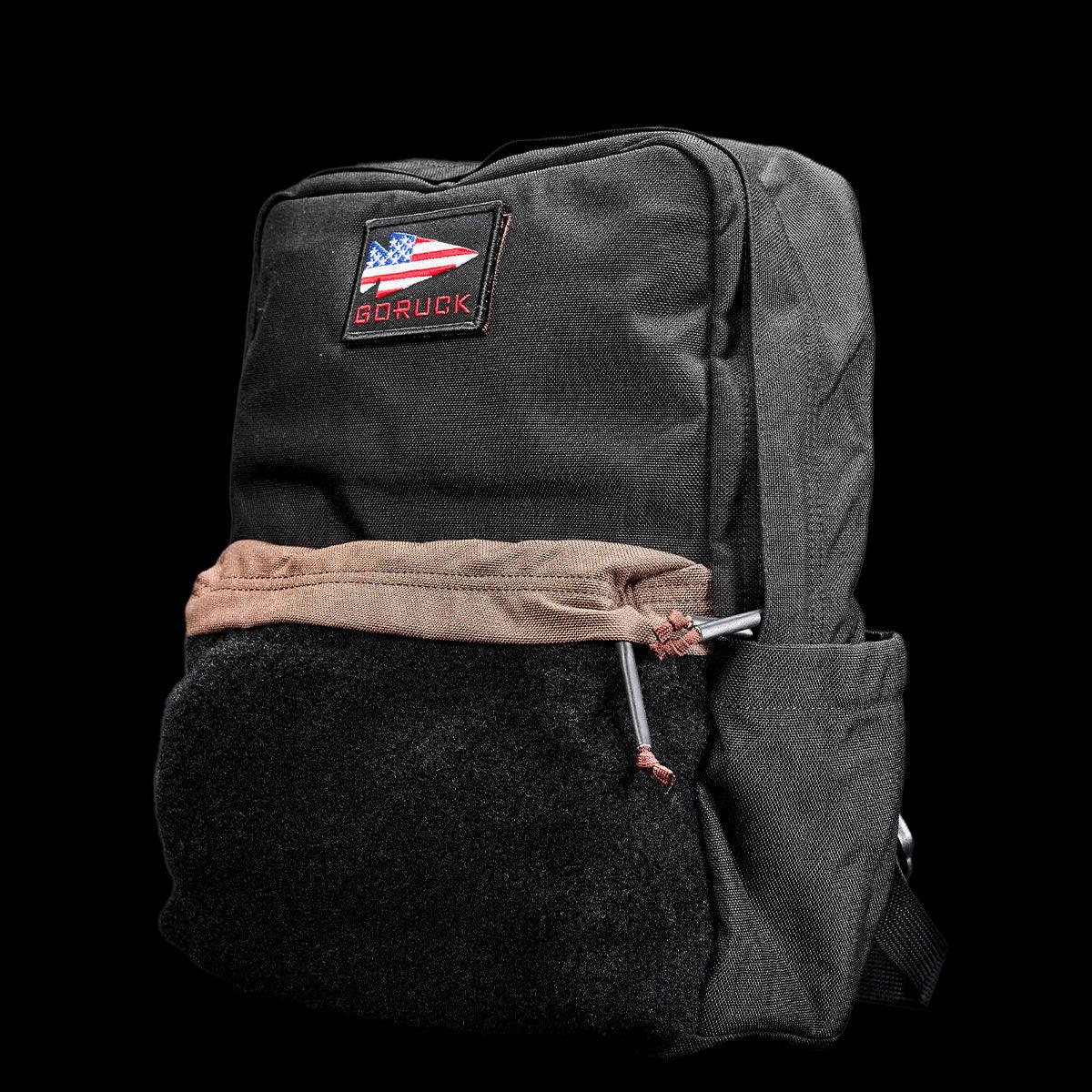 GORUCK Kid Ruck backpack in black with brown drawstring and American flag patch on front