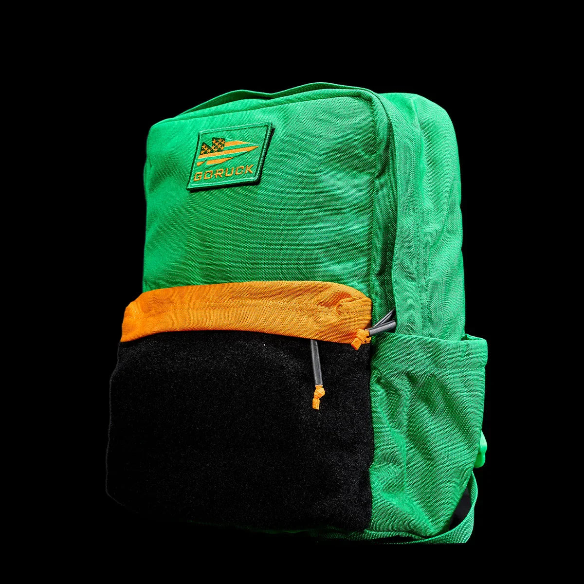 GORUCK KidRuck backpack in bright green with orange and black front pockets, durable rucking gear