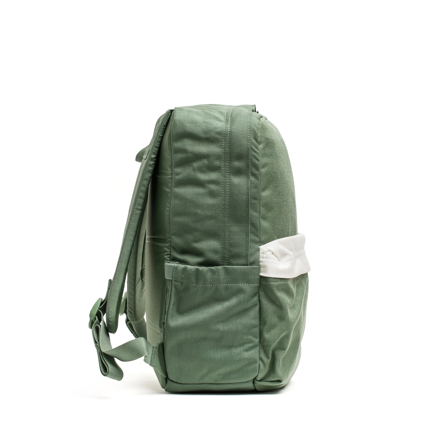 Side view of green GORUCK durable rucking backpack with white accent pocket on white background