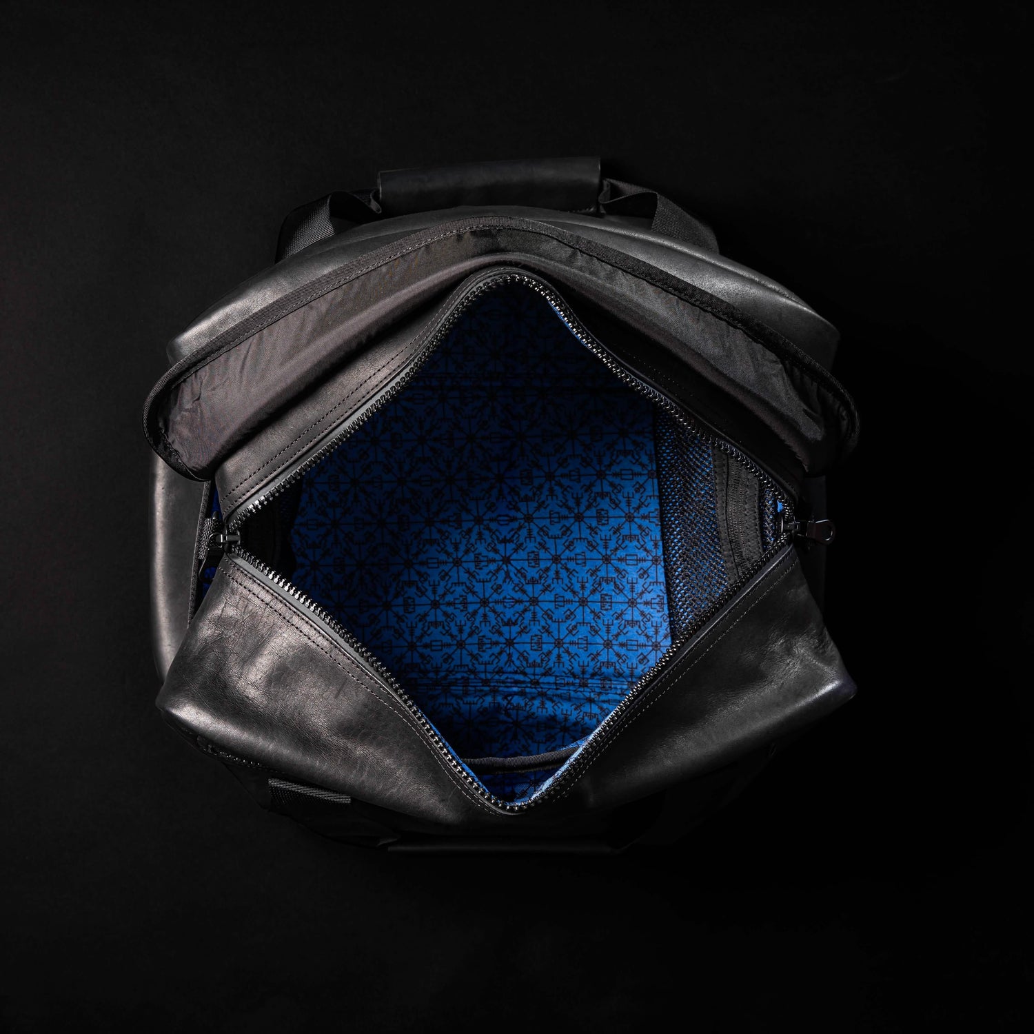 GORUCK Kit Bag 32L black leather open, showing blue patterned interior on black background
