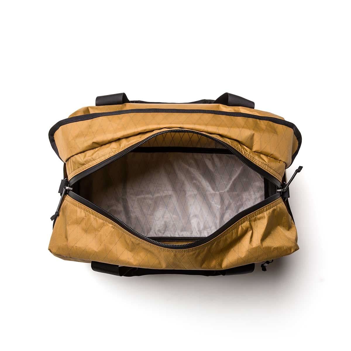 A top view of an open tan Kit Bag - X-PAC, inspired by Special Forces, featuring a visible empty interior and black zipper.