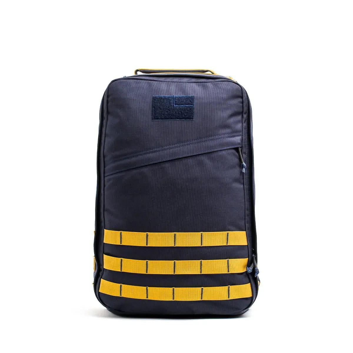GORUCK navy blue rucksack with yellow MOLLE webbing and top handle, front view on white background