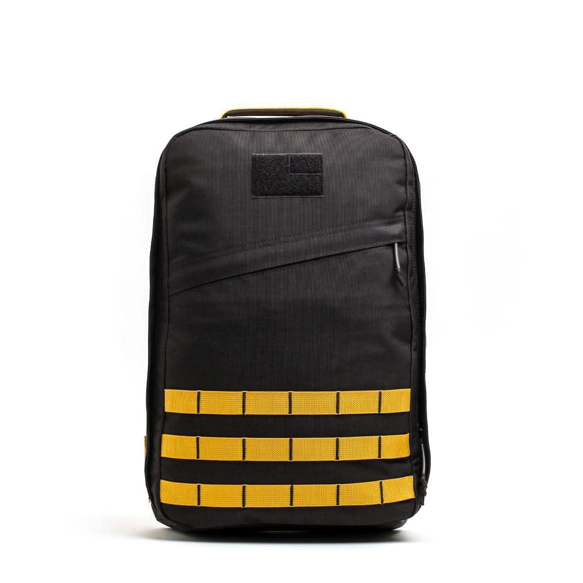 GORUCK black tactical backpack with yellow MOLLE webbing and top handle for rucking and outdoor gear