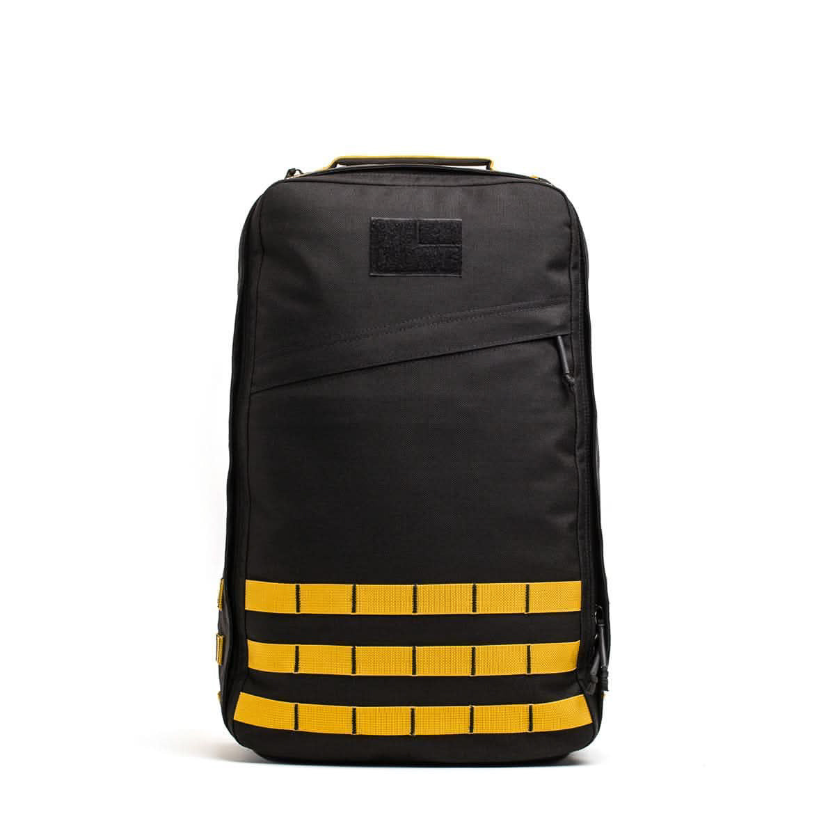 A GR1 USA - Cordura rucksack in black with yellow straps and accents, standing upright against a plain white background.
