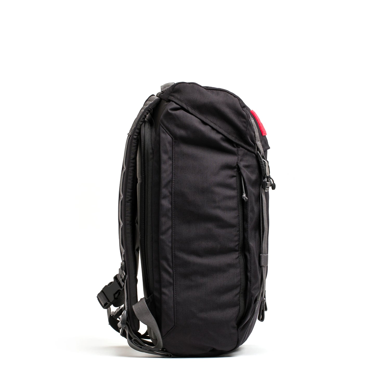Side view of a black GORUCK tactical rucking backpack with padded straps and multiple compartments