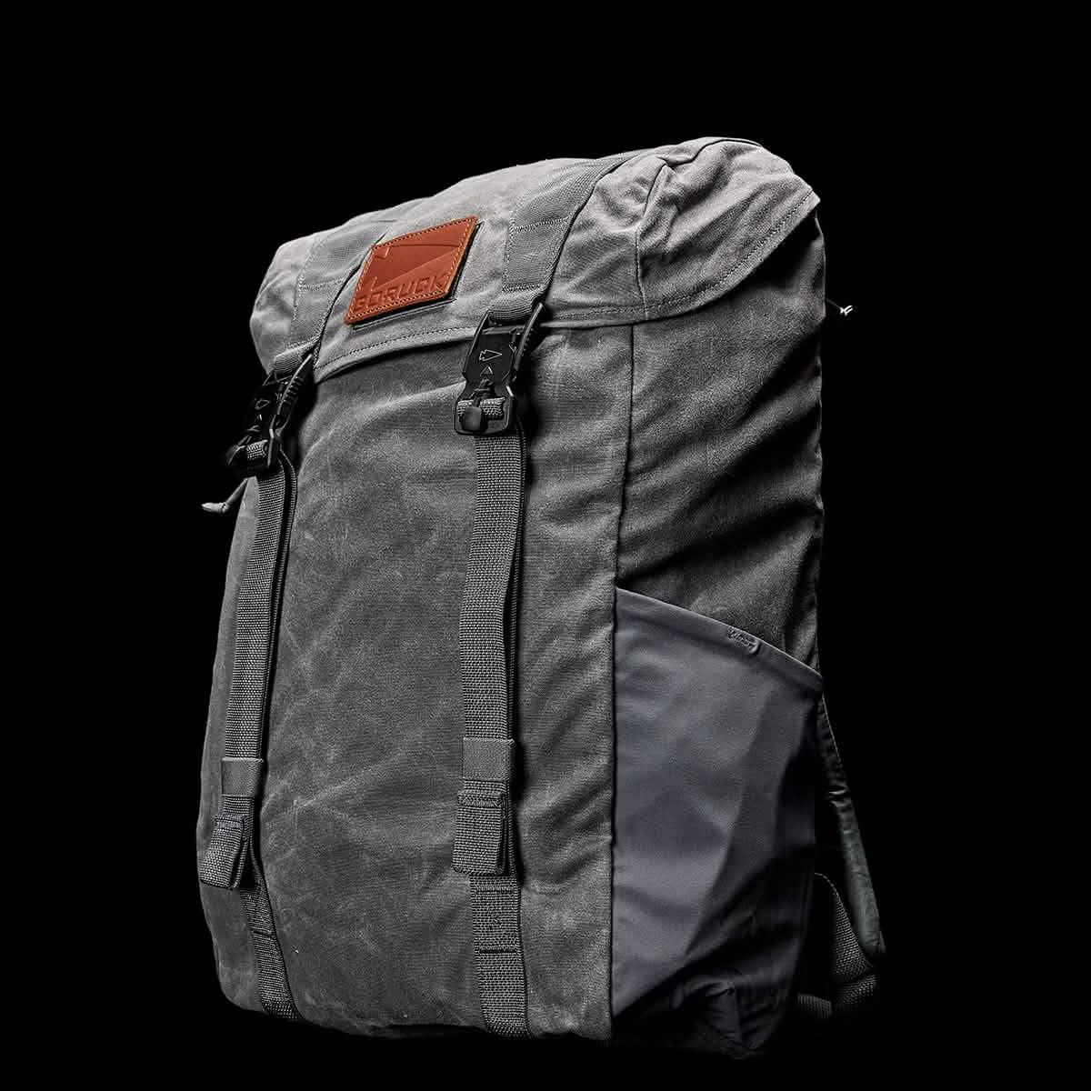 GORUCK slate gray rucksack with leather patch and front buckles on black background