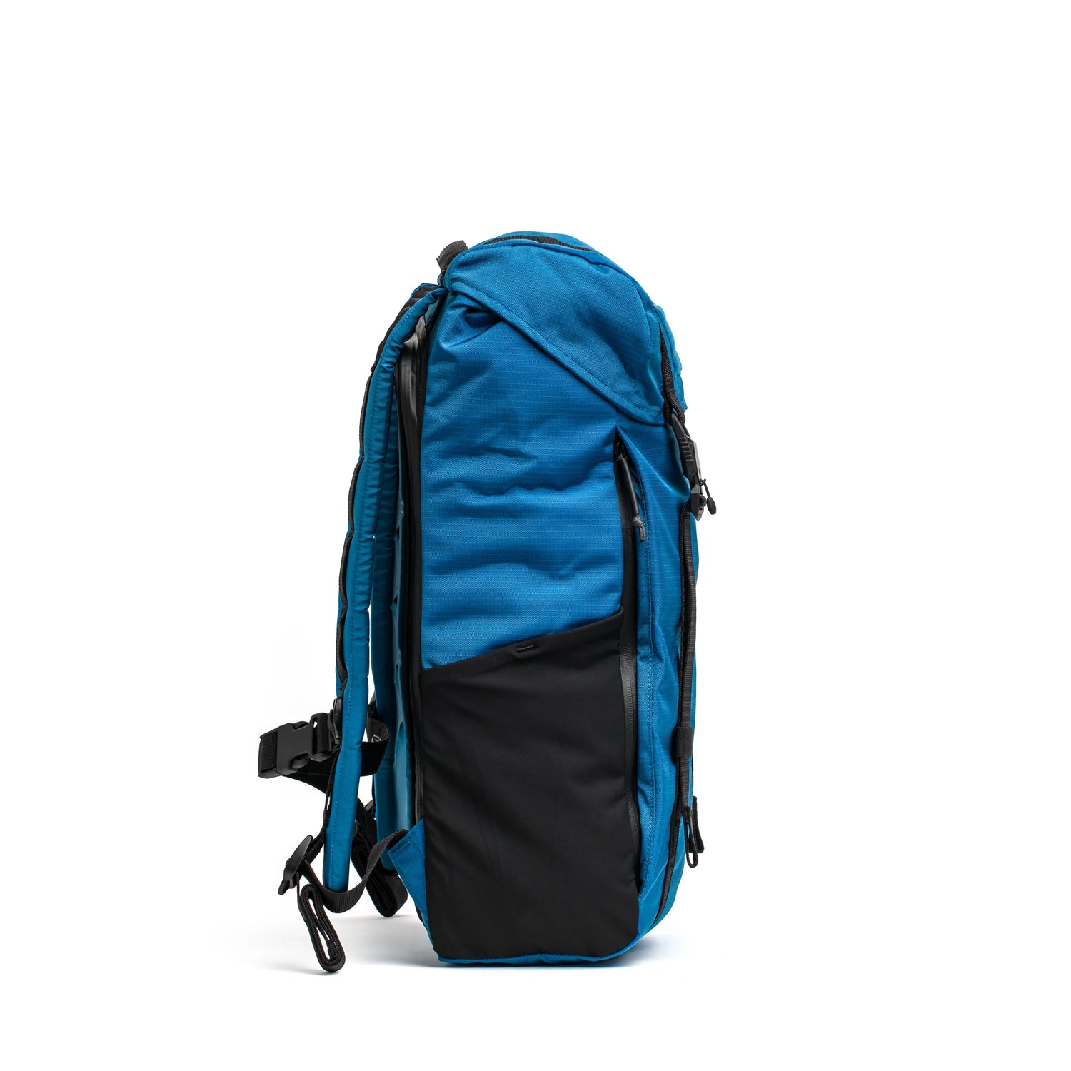 GORUCK dark blue rucksack with black front pocket, side view on white background