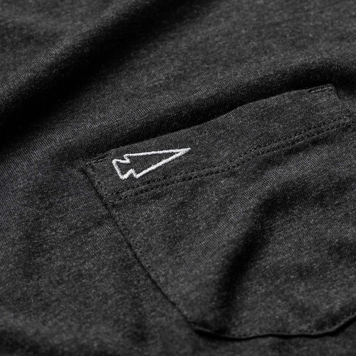 Close-up of black men's long sleeve triblend shirt pocket with white embroidered speartip logo