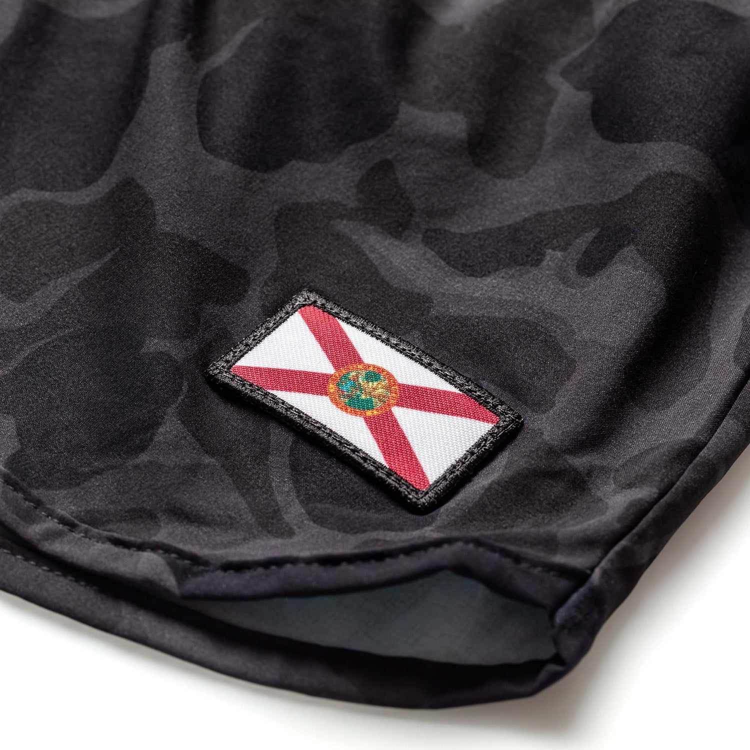 The Men’s Ranger Panties - ToughStretch feature black camouflage fabric and a sewn-on Florida state flag patch near the edge, perfect for PT shorts or classic ranger panties style.