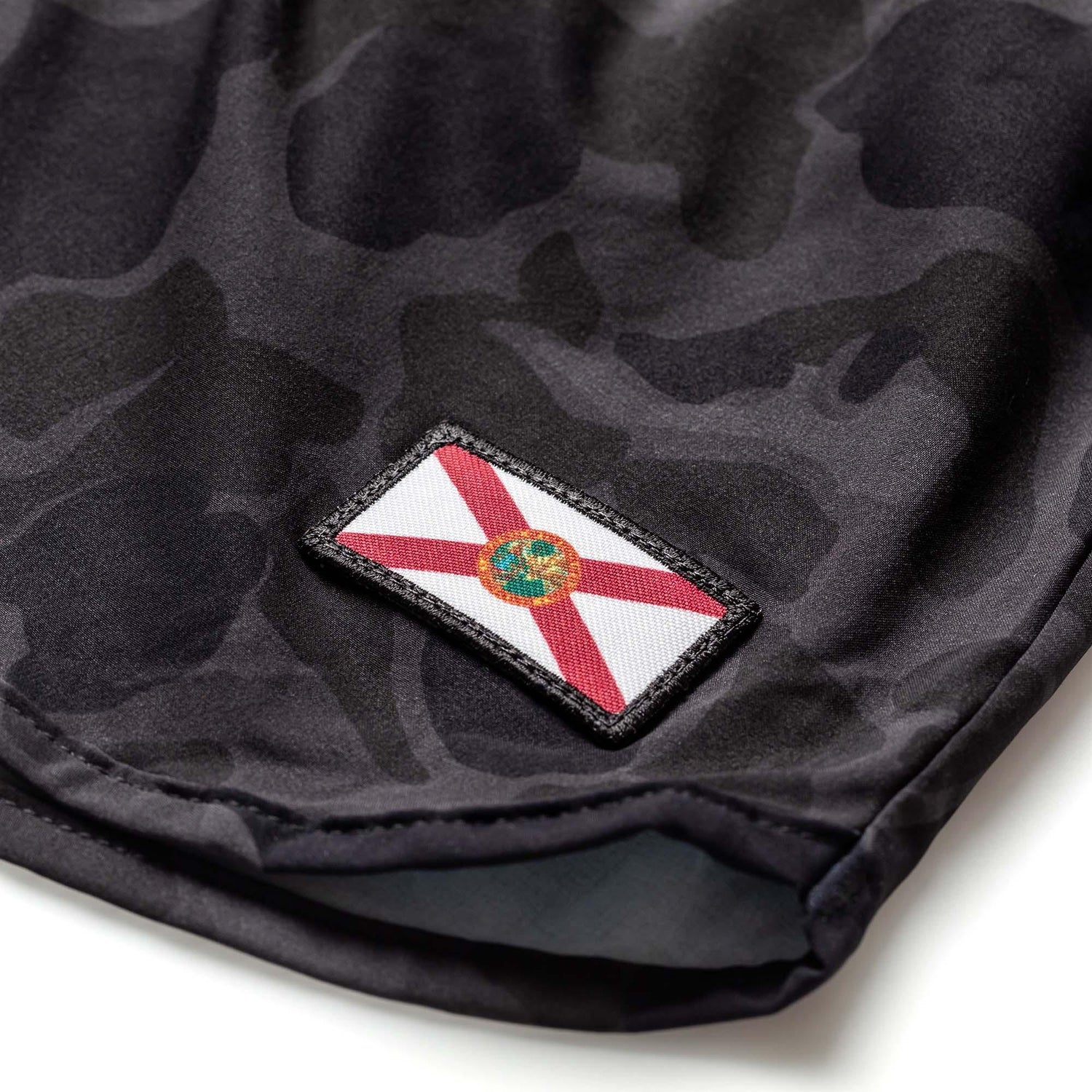 Close-up of black frogskin camo fabric with Florida flag patch on men's GORUCK Ranger panties