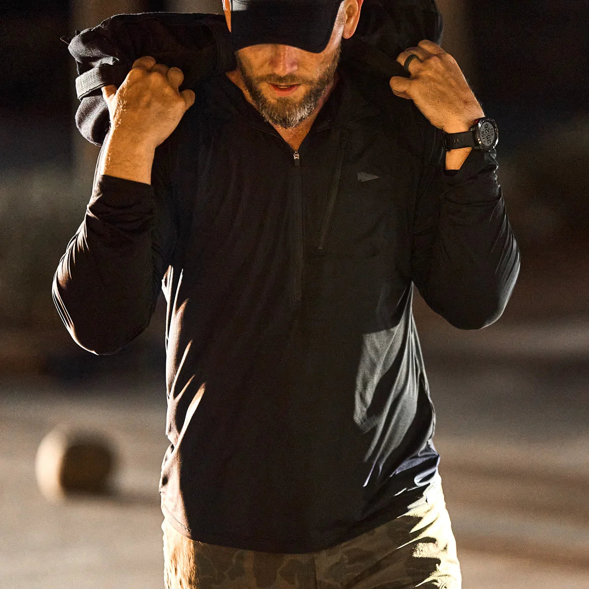 Man wearing GORUCK men's USA longsleeve performance half zip shirt, rucking outdoors