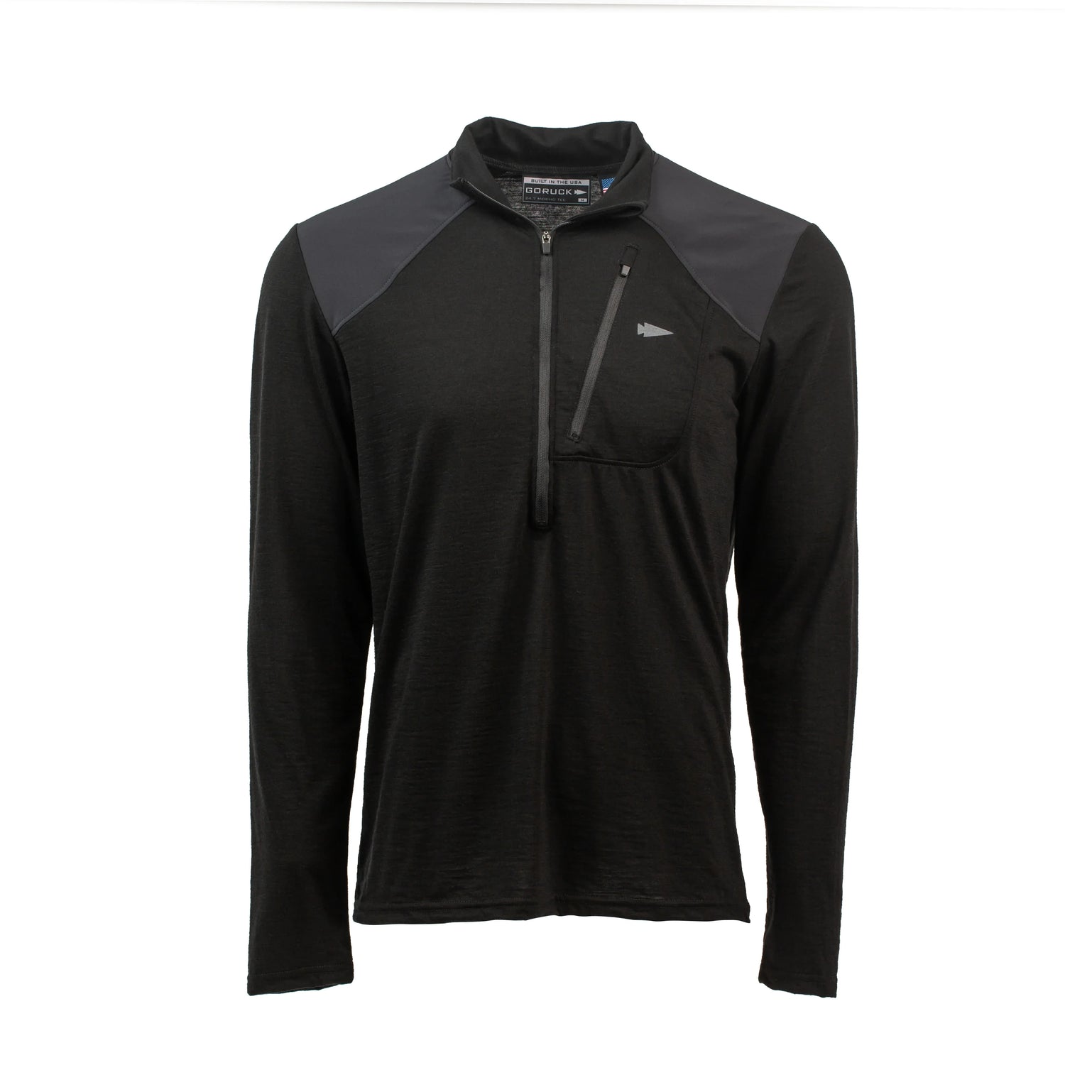 The Men’s Commando Half Zip - Merino Wool is a black long-sleeve pullover featuring a front zipper, chest pocket, and reinforced shoulders for durability—a modern twist on the classic Commando Sweater.