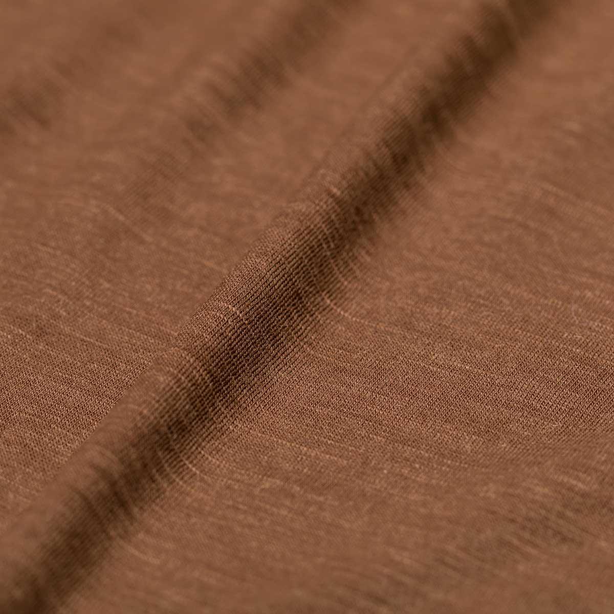 Close-up of GORUCK brown merino wool fabric texture, durable rucking gear material