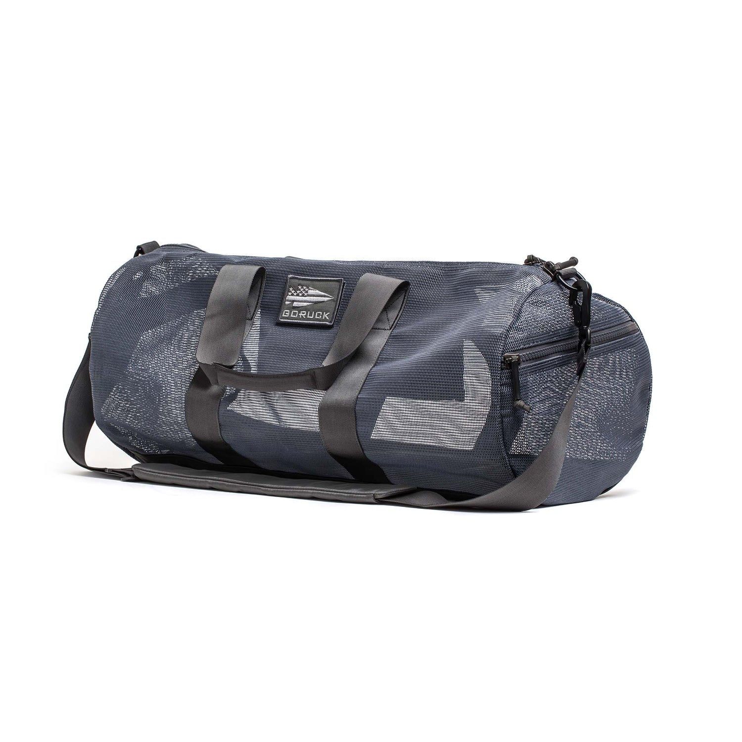 The Mesh Gym Bag features a dark gray design with black handles, zippered pockets, and an adjustable shoulder strap.