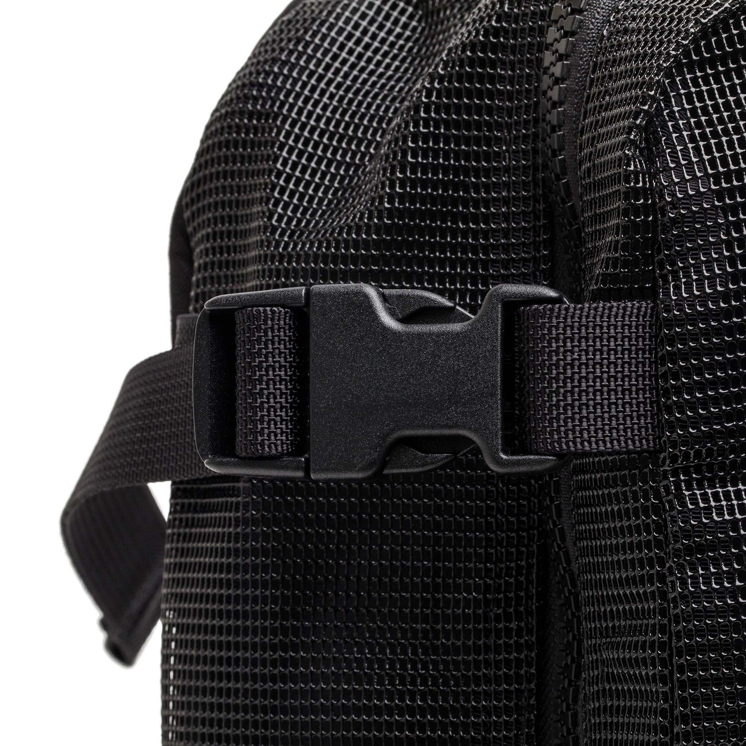 Close-up of a black plastic buckle secured on the textured black strap of the Mesh Ruck quick-drying backpack.