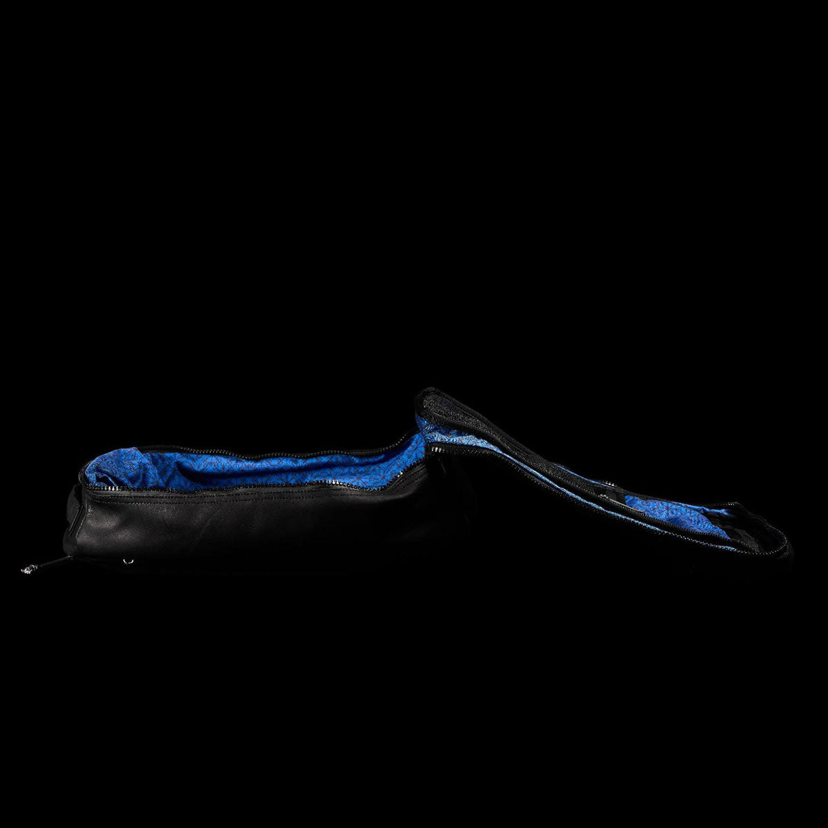 A black zippered bag with a blue interior is open against a black background.