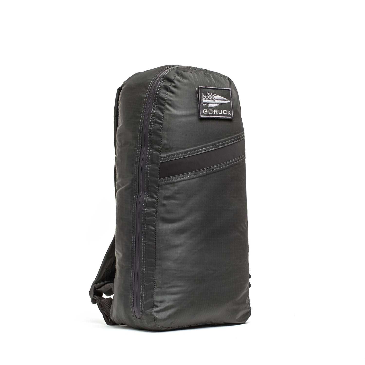 A sleek black Packable Bullet Ruck - Ripstop ROBIC® stands upright on a white background, displaying its front and side as a lightweight day bag.