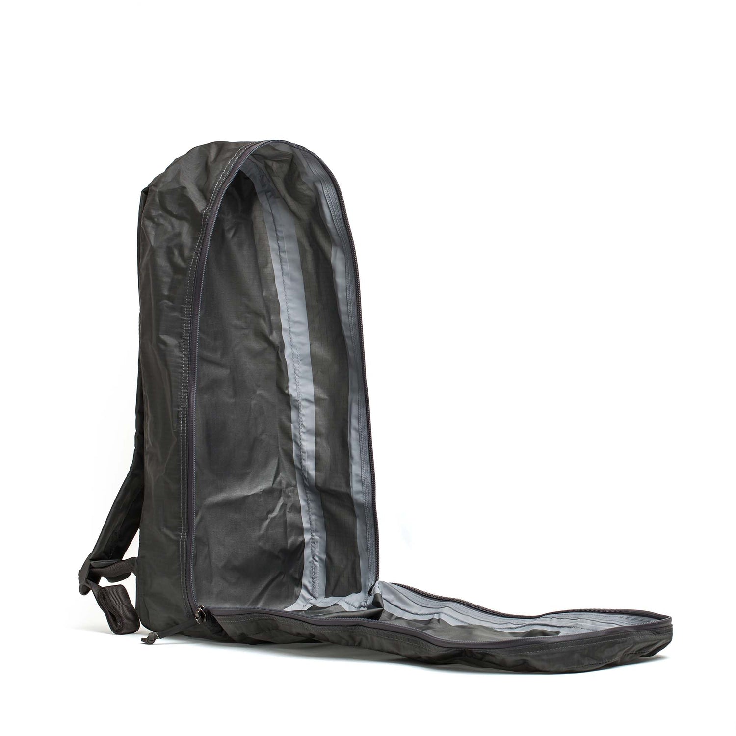 The Packable Bullet Ruck - Ripstop ROBIC® is shown empty, fully unzipped and upright on a white background—highlighting its sleek, lightweight design and durable AquaGuard zippers.
