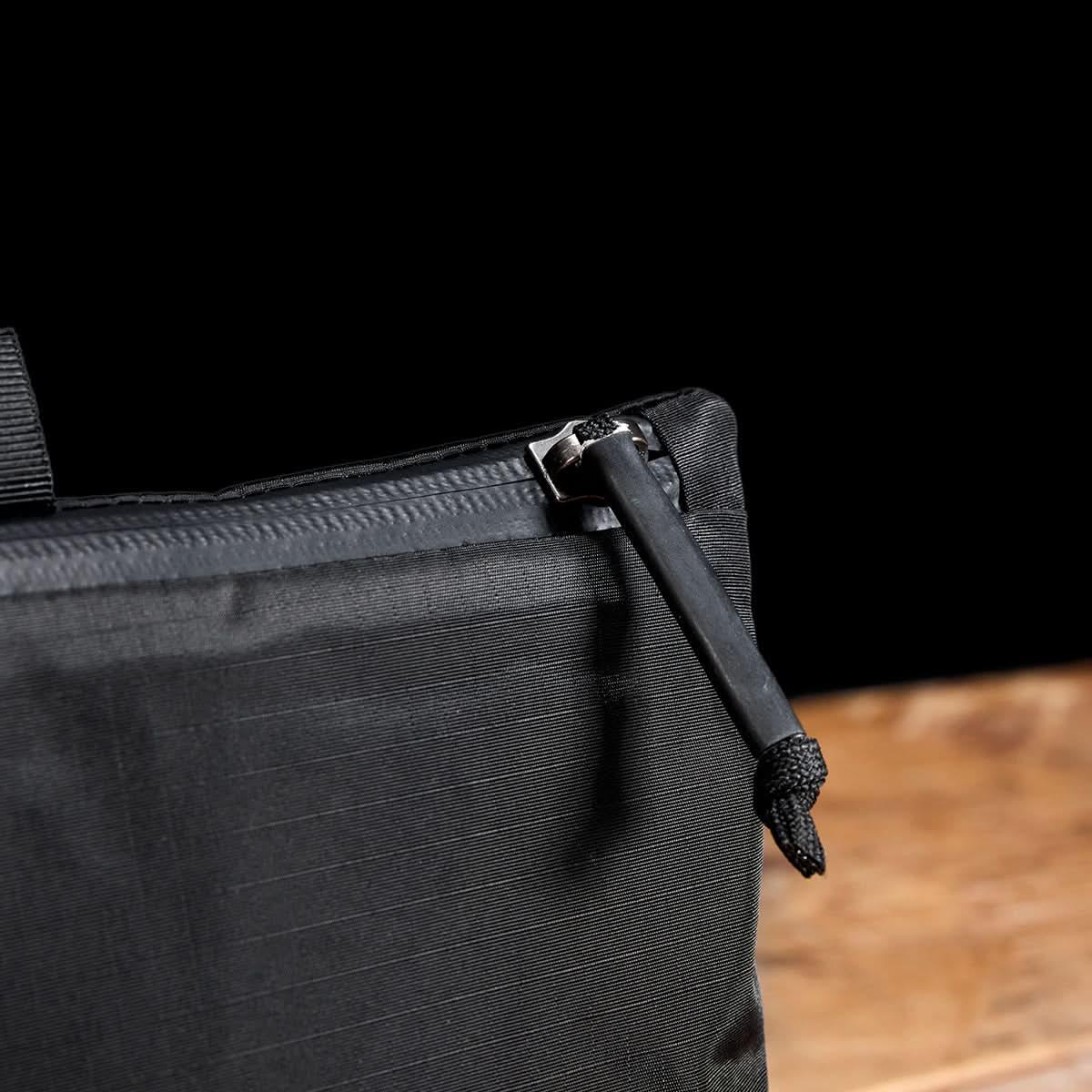 Close-up of GORUCK black rucksack zipper pull and durable fabric details