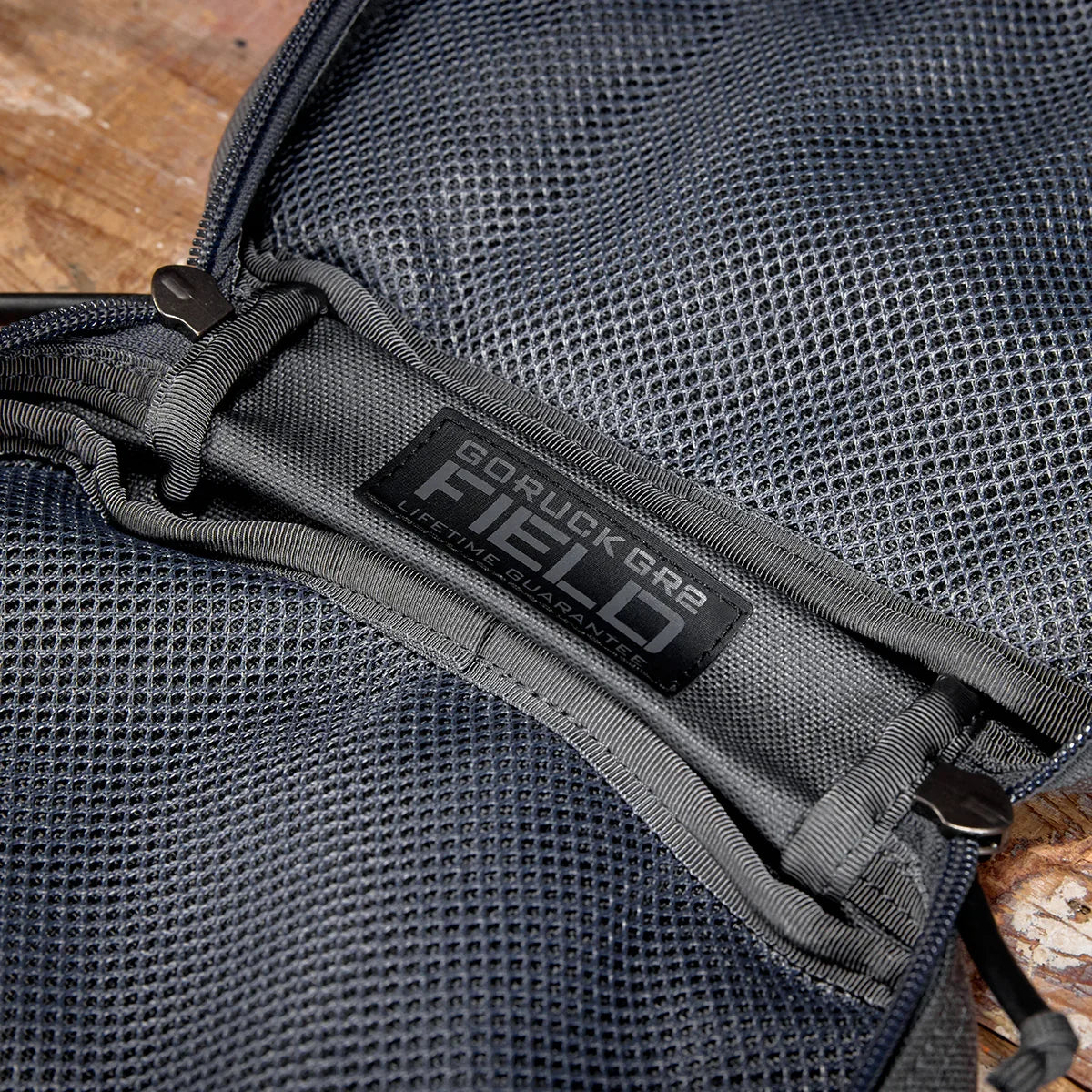 Close-up of GORUCK GR2 FIELD patch on gray padded mesh pocket inside rucksack