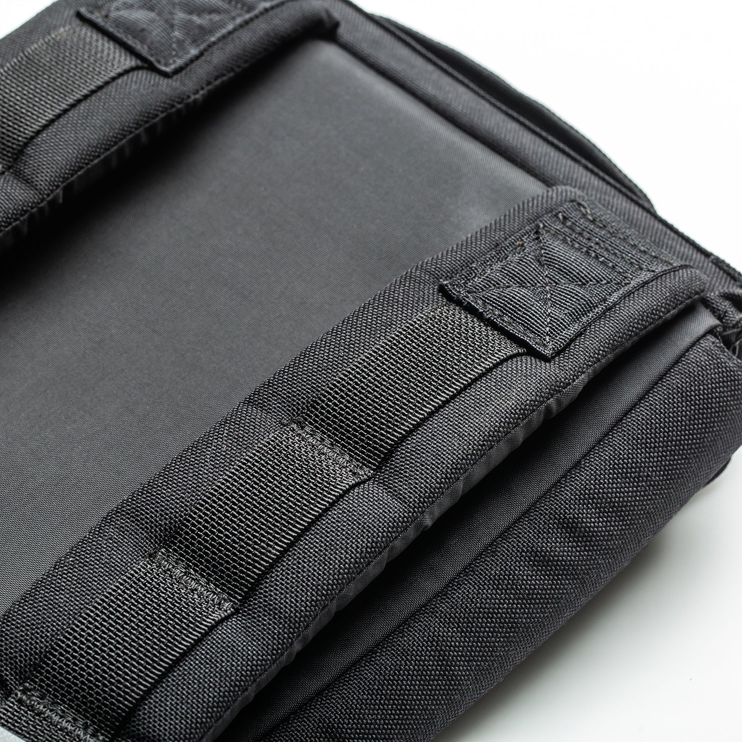 Close-up of a black padded strap and fabric, highlighting stitching and texture on a white background—perfect for use with the RPC 3.0 + 10lb Ruck Sandplate during weighted training sessions.