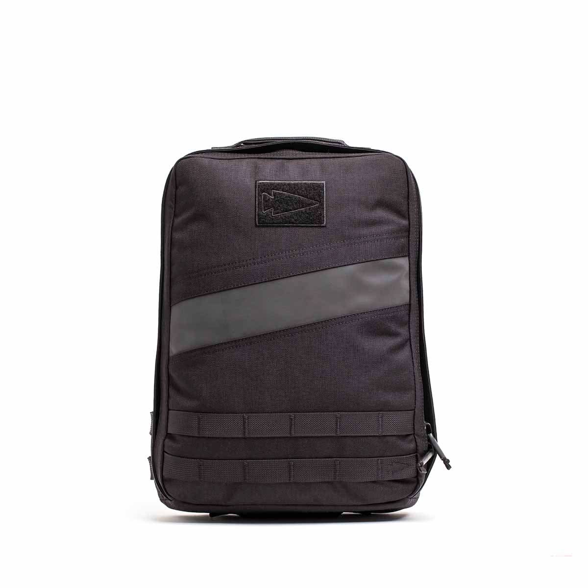 The Rucker 4.0 is a sleek black rucksack featuring a top handle, diagonal accent stripe, and front webbing detail.
