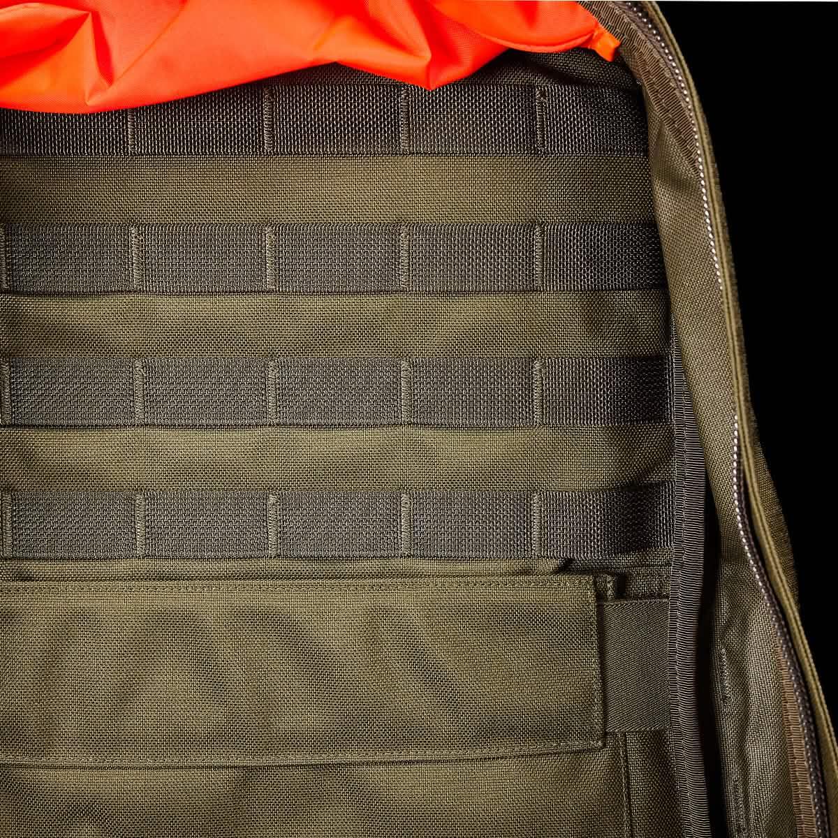 Close-up of ranger green tactical backpack interior with webbing and orange fabric detail