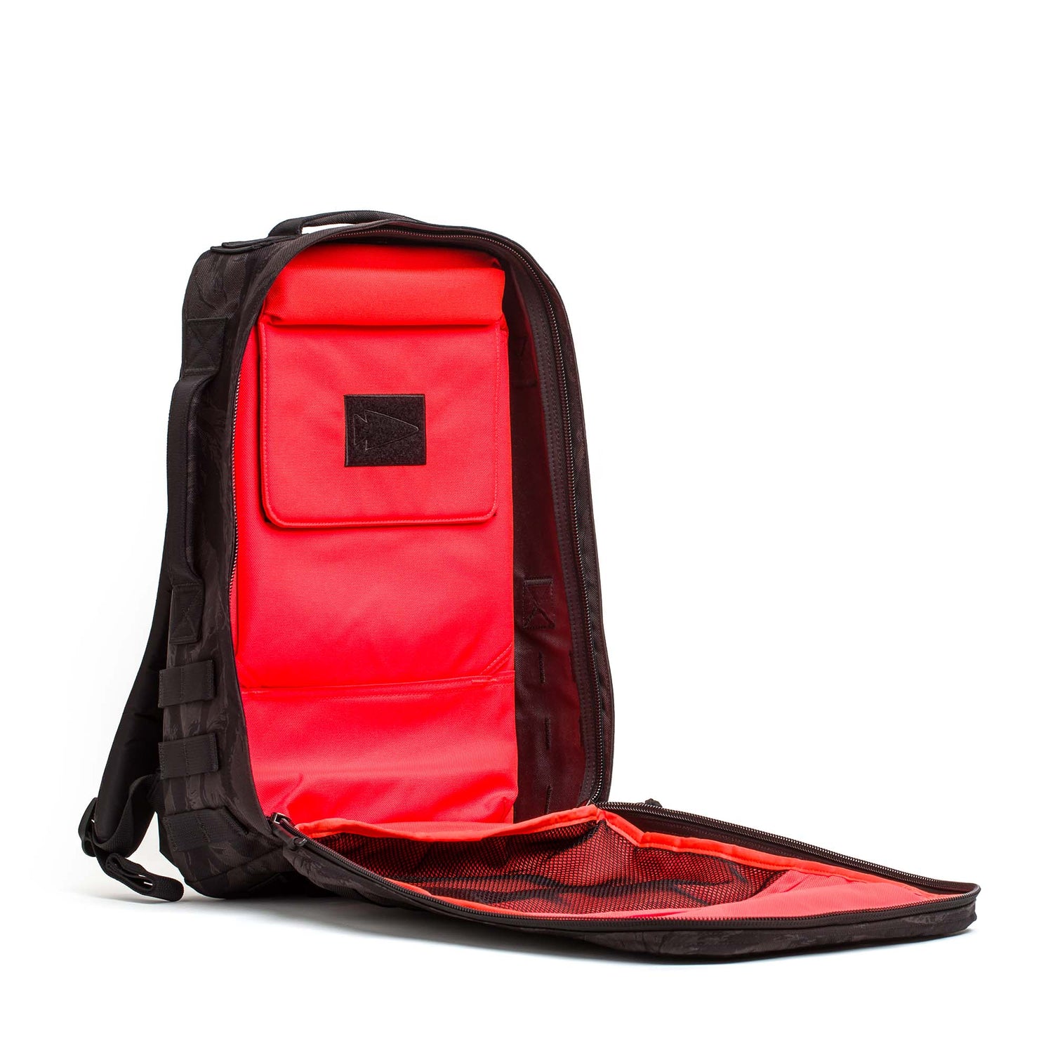 The Rucker 5.0 unzips fully to show its bright red interior, featuring padded sections, mesh pockets, and enhanced lumbar support for comfortable rucking.