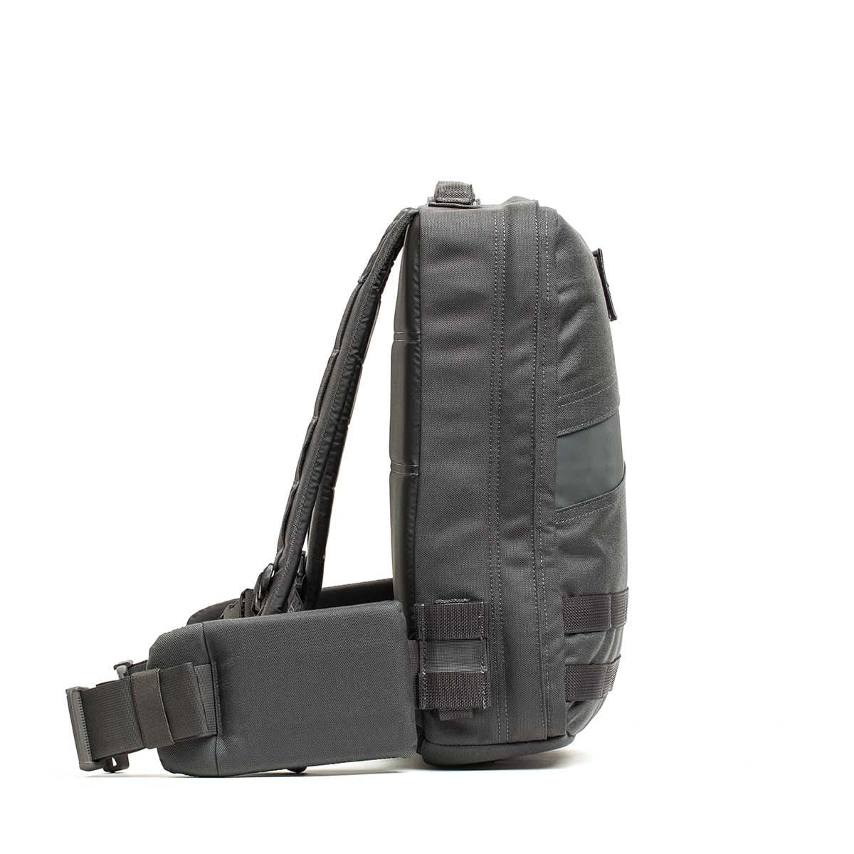 Side view of the dark gray Rucker 4.0 sling backpack featuring an adjustable strap, multiple compartments, and space for Ruck Plates—ideal for rucking or everyday carry.