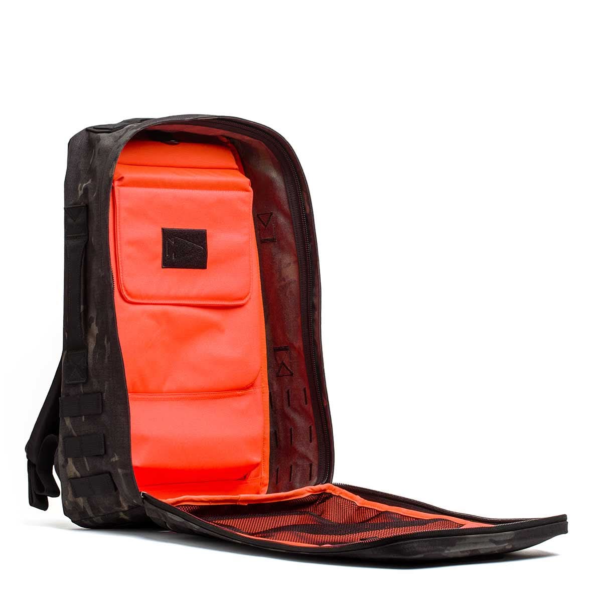 The Rucker 4.0 backpack features a black exterior, fully open zipper, and vivid orange interior with pockets—ideal for rucking or carrying your Ruck Plates in style.