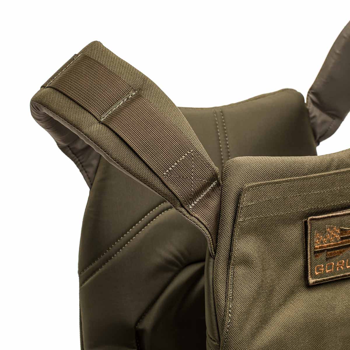 Close-up of an olive green Rucking Weight Vest strap and stitching, highlighting detailed material and texture—ideal for carrying Curved Ruck Plates during your next rucking session.