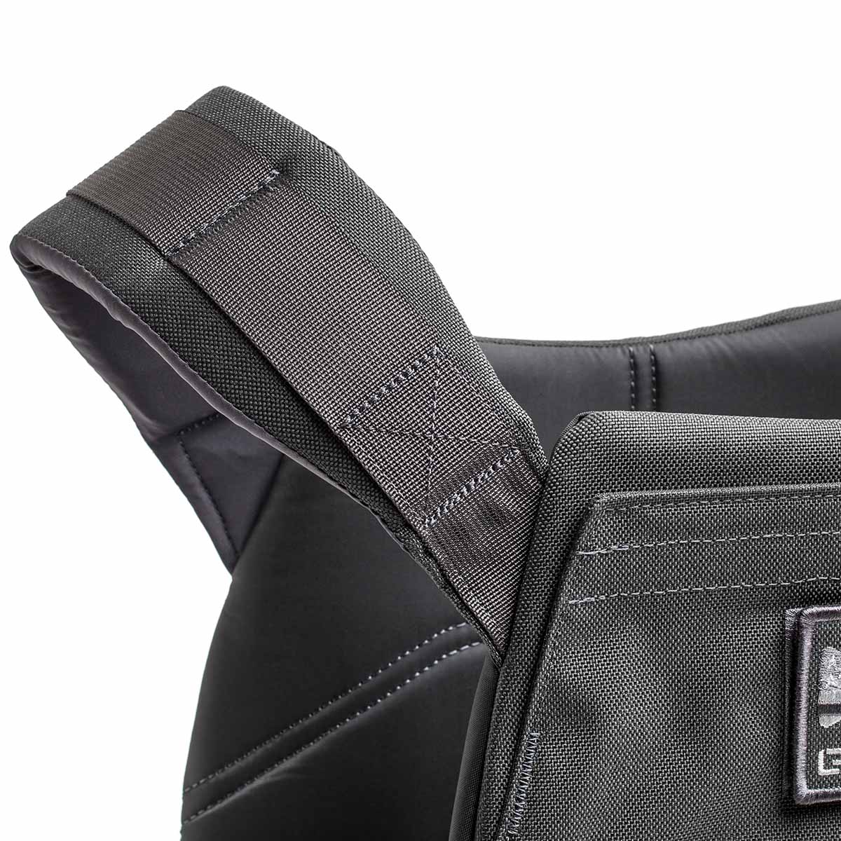 Close-up of a padded black shoulder strap on the Rucking Weight Vest, featuring visible stitching and designed for comfort during workouts with Curved Ruck Plates.