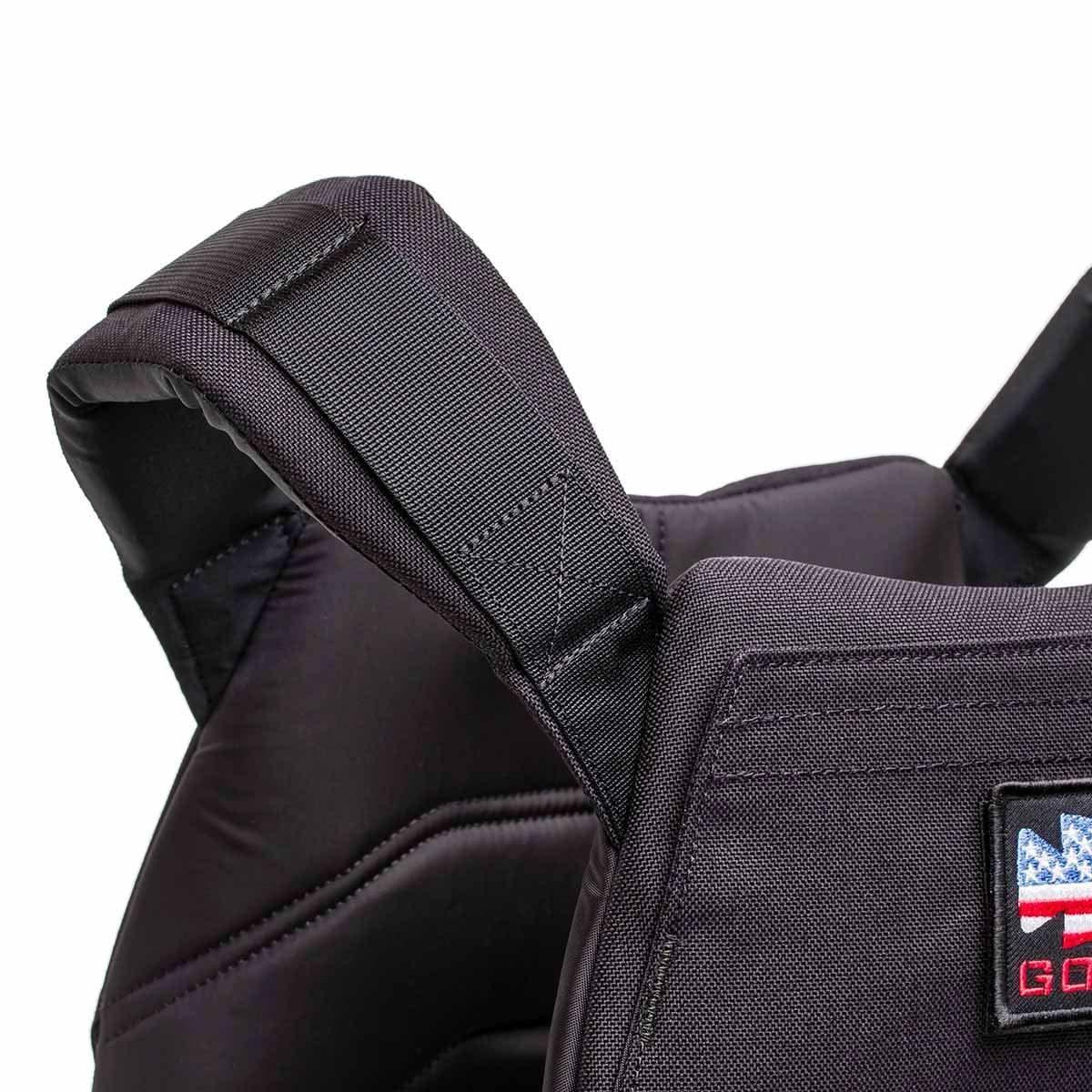 Close-up of black GORUCK rucking weight vest shoulder strap and padded back panel with logo patch