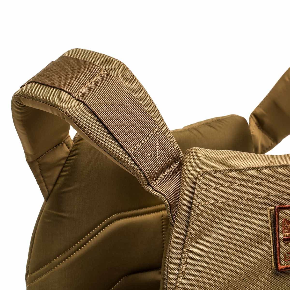 Close-up of a padded, tan fabric shoulder strap on the Rucking Weight Vest with visible stitching and quilted details—designed for comfort and support during weighted training.