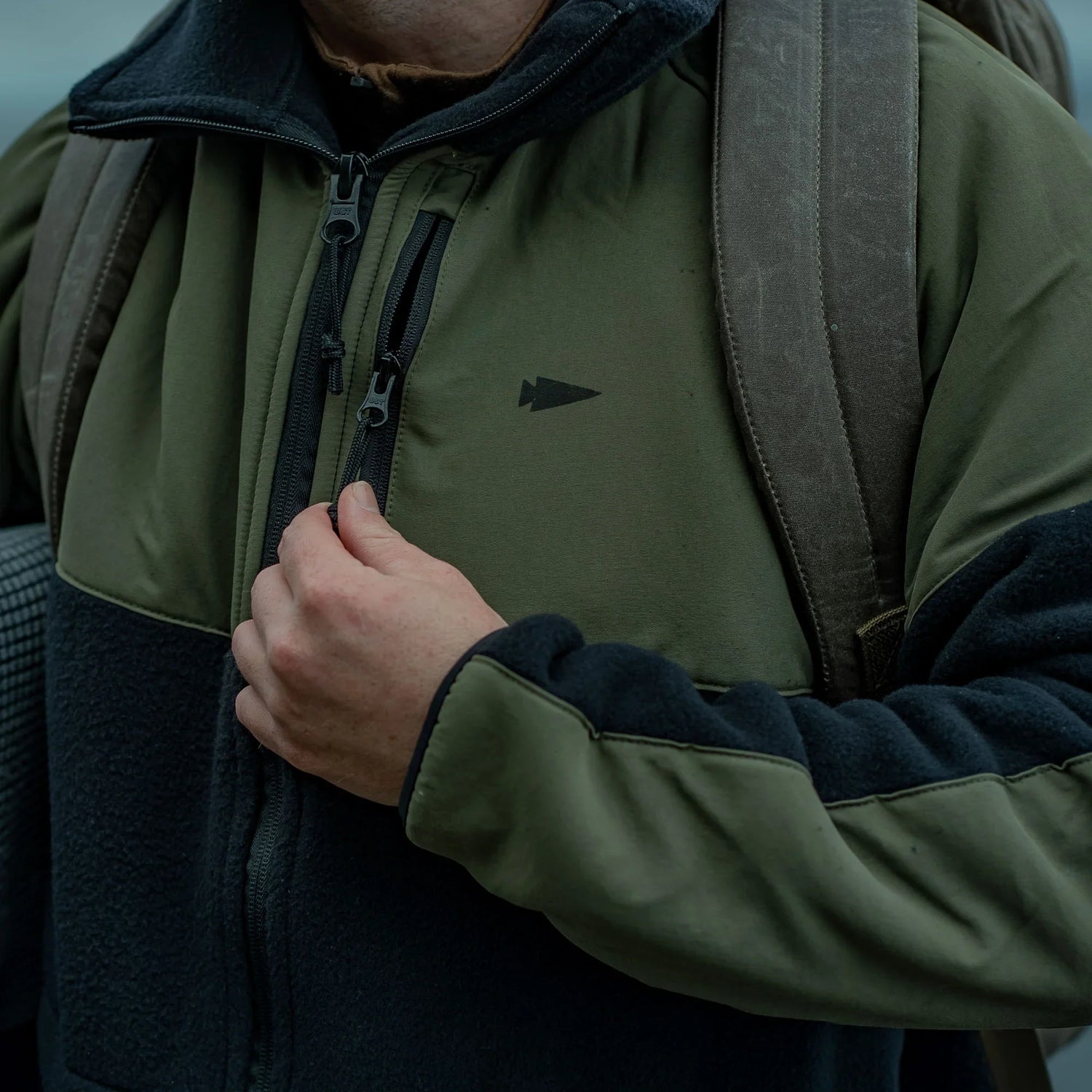 GORUCK rucking jacket in olive and black with backpack strap outdoors